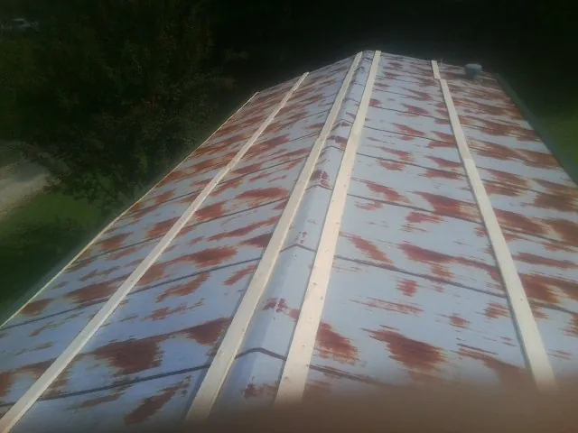 Rusted metal roof panels with new wood purlins before replacement — Storm Damage Roof Repair in Clark Fork by Roofing Brothers